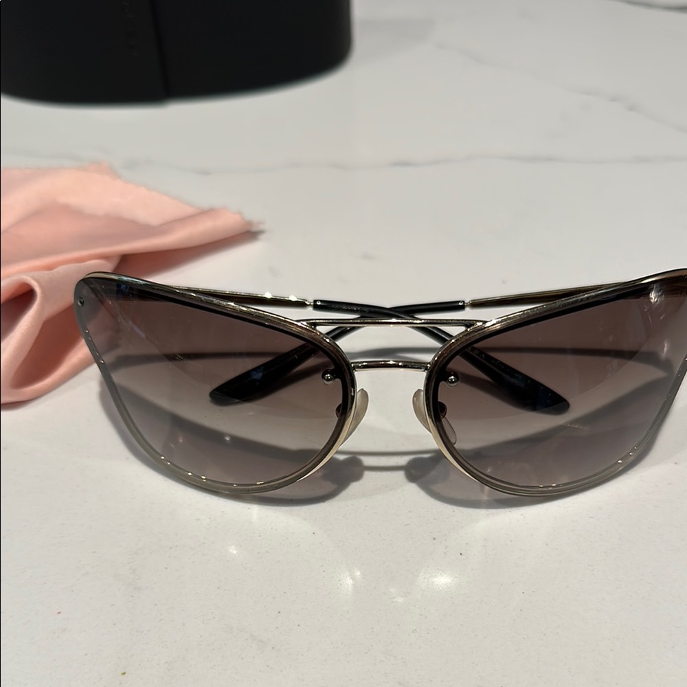 Prada PR74VS sunglasses butterfly silhouette with a metallic gold frame. - Picture 8 of 12
